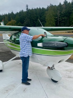 Len Warden checks his plane